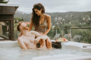 a couple laughing together while using their hot tub - buying a hot tub